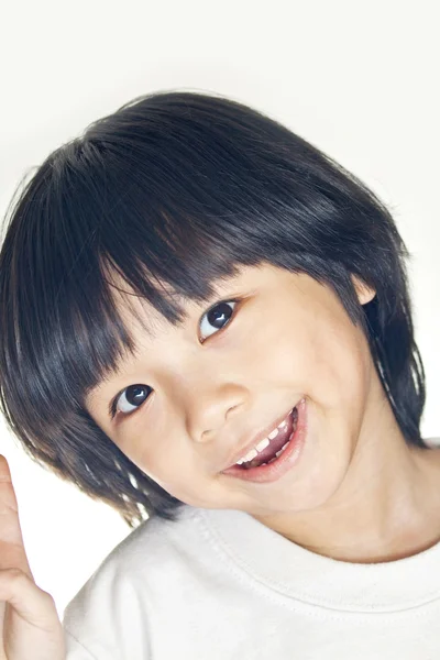 stock image A young asian girl smiling, studio shot.