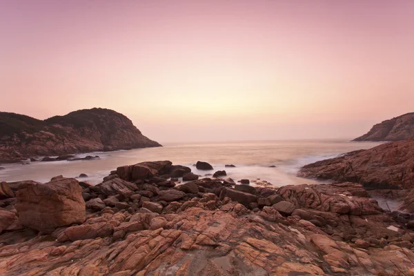 Meeressteine entlang der Küste bei Sonnenaufgang — Stockfoto