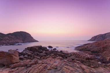 Sea rocks along the coast at sunrise clipart