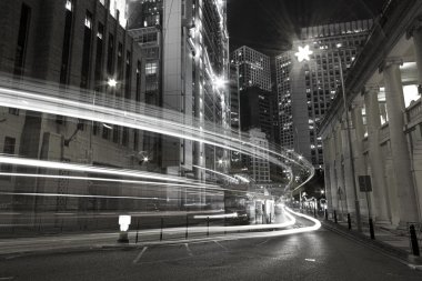 Traffic in city at night in black and white toned clipart