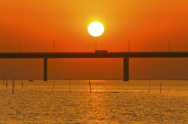 Sunset over a bridge in Hong Kong clipart