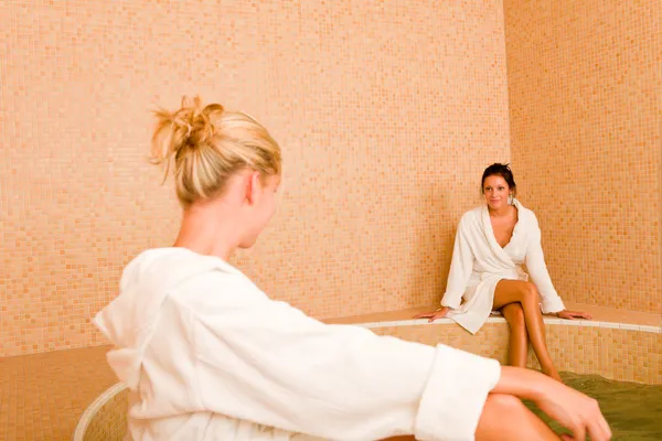 Relax spa pool two women sitting bathrobe — Stock Photo, Image