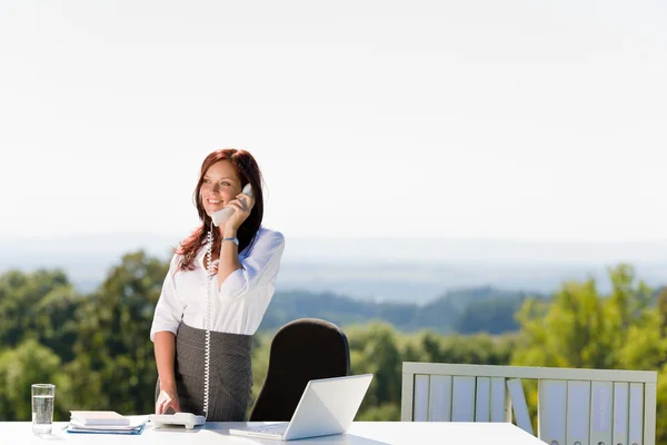 Businesswoman in sunny nature office calling — Stock Photo, Image