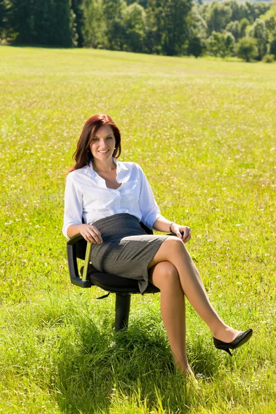 Attractive businesswoman sit armchair sunny meadow — Stock Photo, Image