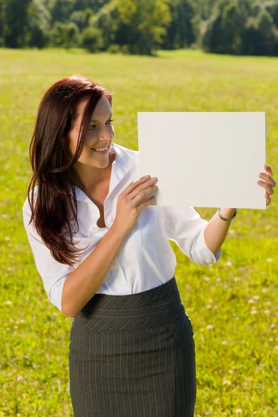Businesswoman sunny meadow look at empty banner — Stock Photo, Image