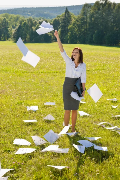 Businesswoman sunny meadow throw papers freedom — Stock Photo, Image