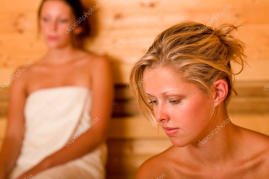 Naked young woman with towel at hot spring talking Stock 