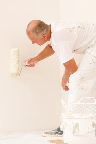 Home decorating mature man with paint roller — Stock Photo, Image