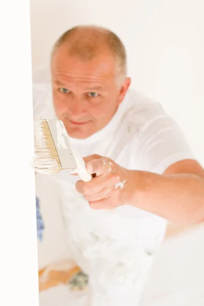 Home decorating mature man painting wall brush — Stock Photo, Image