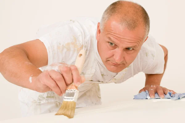 Home decorating mature man painting door brush — Stock Photo, Image