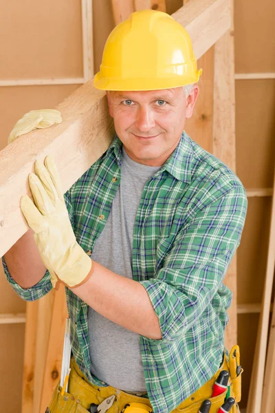 Handyman carpenter mature carry wooden beam — Stock Photo, Image