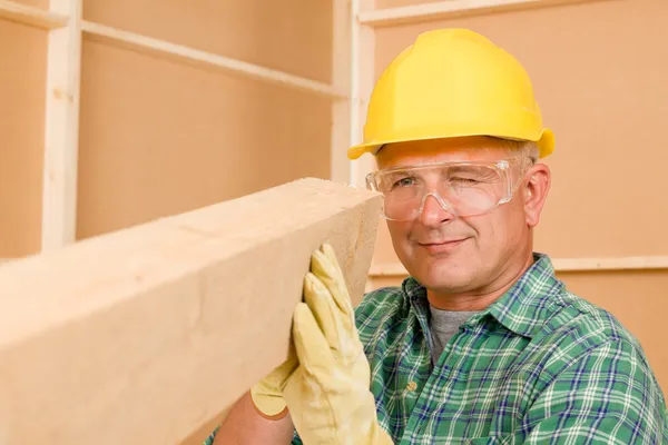 Handyman mature carpenter measure wooden beam — Stock Photo, Image