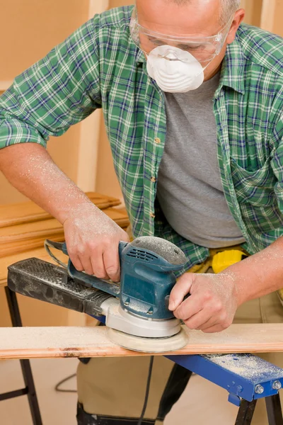 Handyman sanding wooden board diy home renovation — Stock Photo, Image