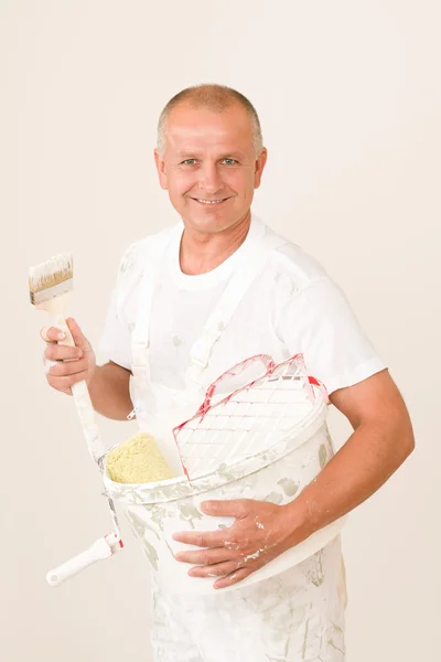 Home decorating mature man with paint brush Stock Photo