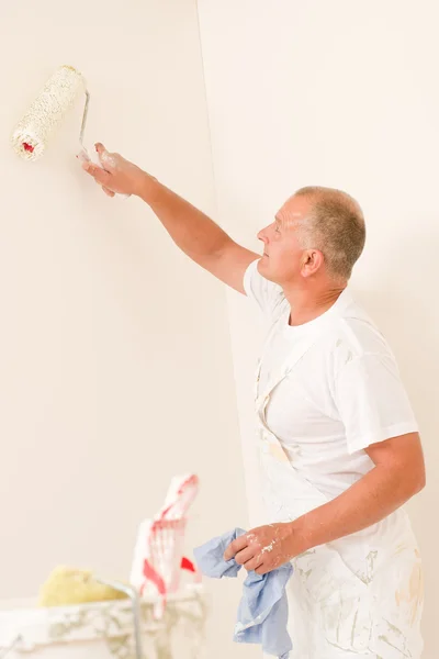 Home decorating mature man with paint roller Royalty Free Stock Photos