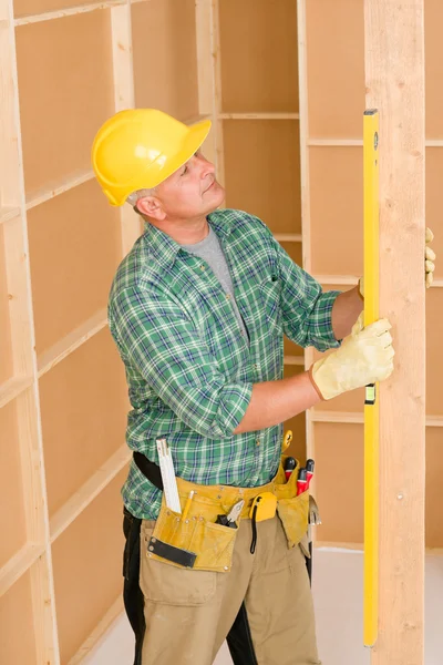 Handyman mature professional with spirit level Royalty Free Stock Images