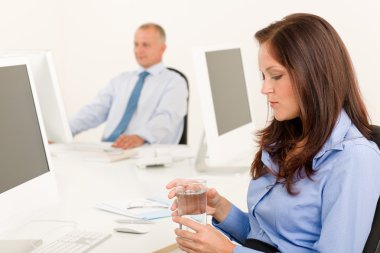 Businesswoman sit in office hold water glass clipart