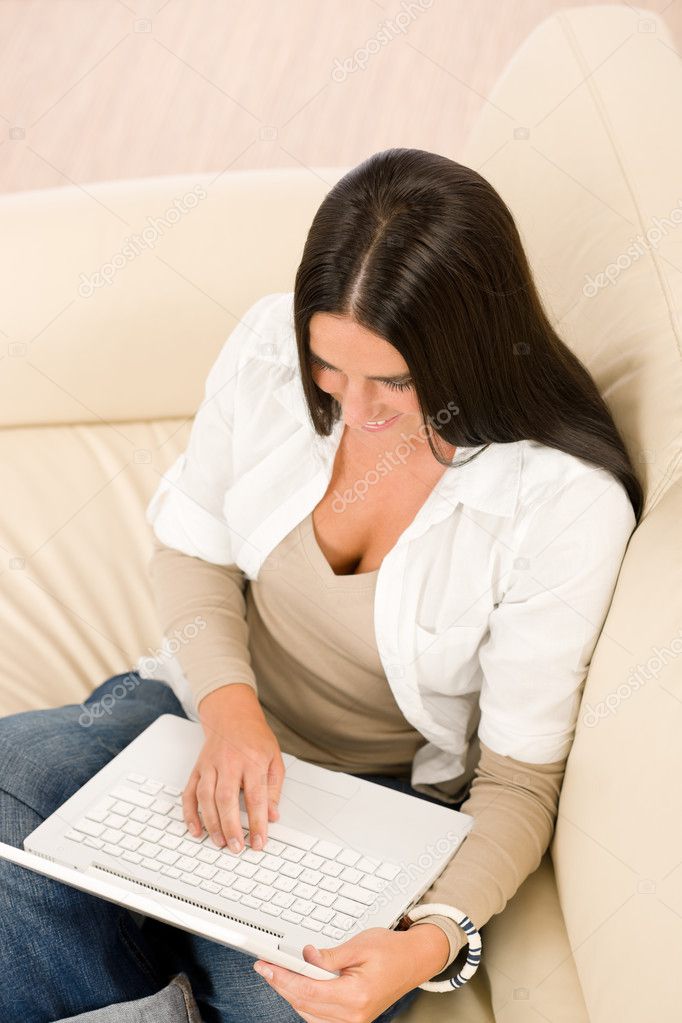 Woman with laptop sitting couch relax home