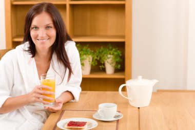 Breakfast home happy woman with orange juice clipart