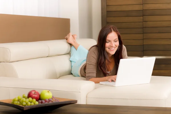 Современная гостиная женщина лежит диван ноутбук — стоковое фото