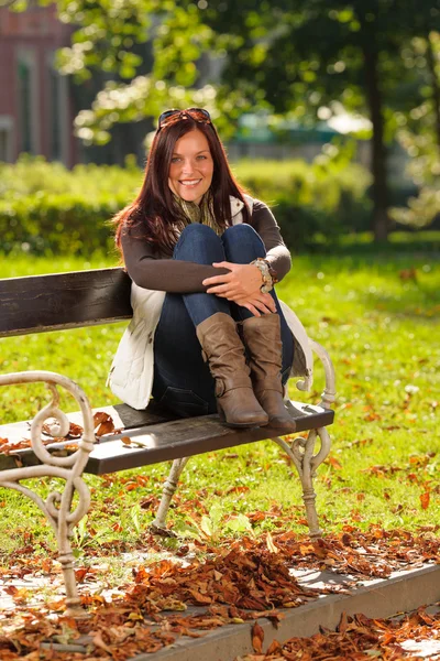 Autumn sunset park woman sitting on bench — Stock Photo, Image