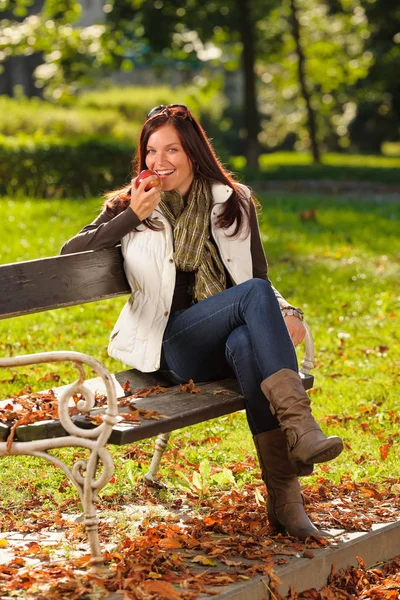 Outono mulher atraente comer maçã pôr do sol parque — Fotografia de Stock