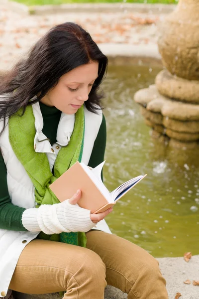 Autumn fountain young woman read book — Stock Photo, Image