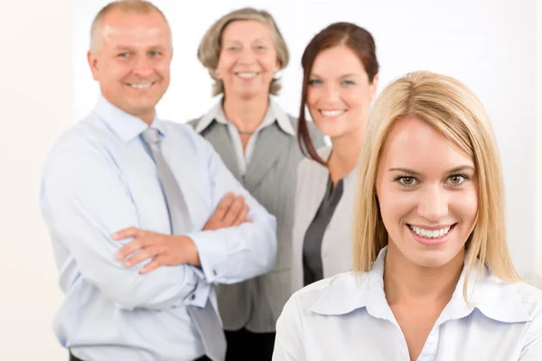 Business team young woman with mature colleagues Stock Image