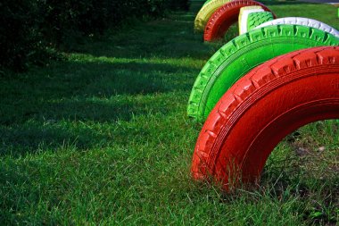 Painted wheels from rubber fixed at playground clipart