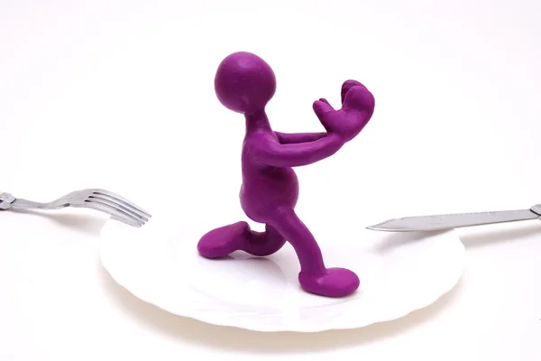 Purple puppet of plasticine begging for life — Stock Photo, Image
