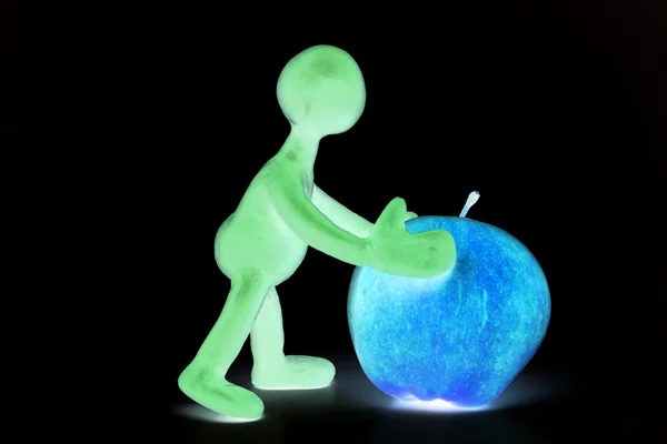 Shaded puppet of plasticine pushing done apple — Stock Photo, Image
