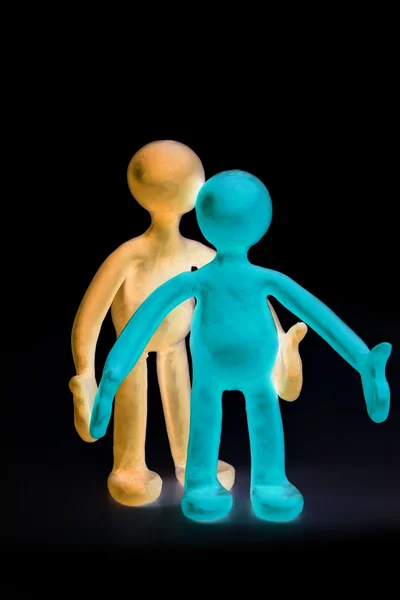 Shaded plasticine puppets standing on black background — Stock Photo, Image