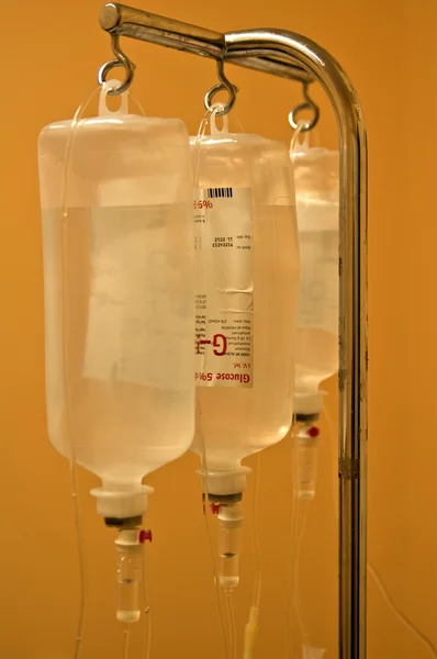 Infusion bottles hanging on metal holder — Stock Photo, Image