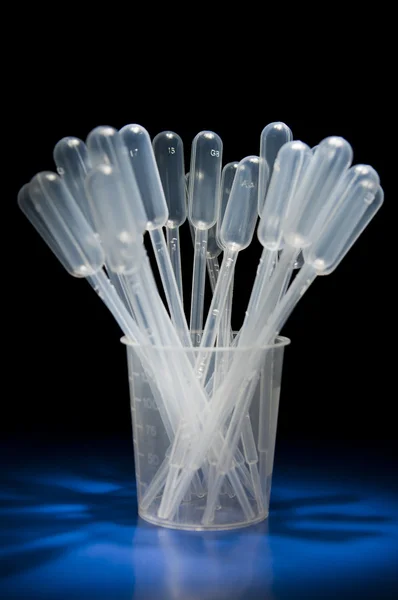 Pack of pipettes standing in measure glass — Stock Photo, Image