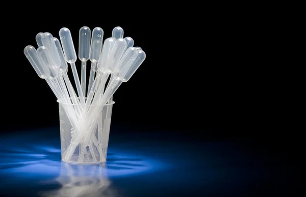 Pipettes standing in glass in studio — Stock Photo, Image