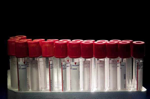 Red test tubes placed at two lines — Stock Photo, Image