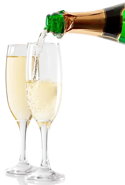 stock image Champagne is poured into two glasses