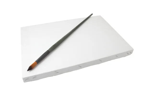 Brush and white canvas — Stock Photo, Image