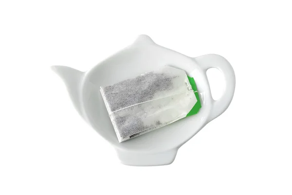Teebeutel auf Untertasse in Teekannenform — Stockfoto