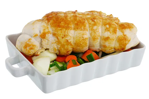 Bound grilled turkey breast with vegetables on baking pan Stock Photo