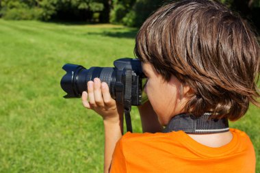 Kid taking shots with photocamera clipart