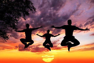 Jumping Yoga silhouettes in lotus clipart