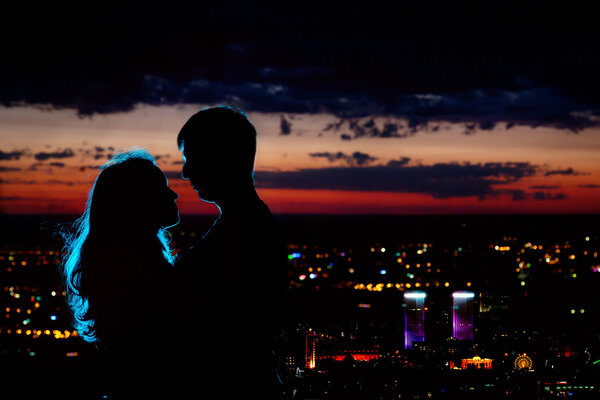 Couple silhouette at night city