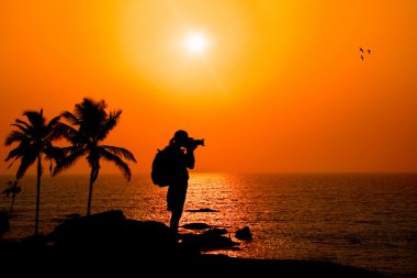 Photographer silhouette at sunset clipart