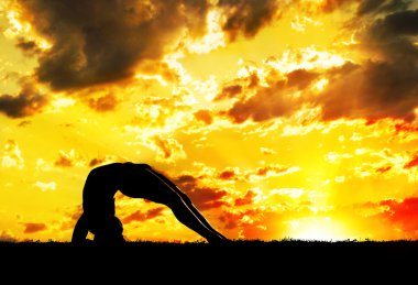 Yoga silhouette at sunset clipart