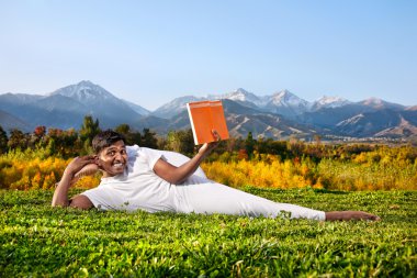 Yoga man reading the book clipart