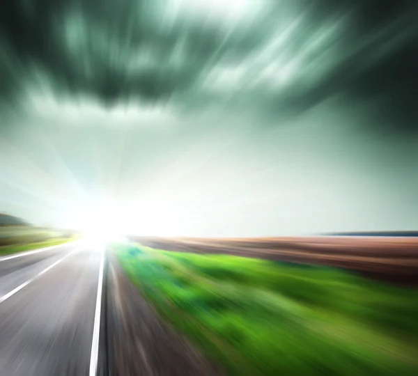Blurred Road with blurred sky with sun — Stock Photo, Image