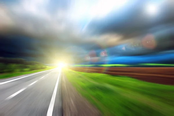 Blurred Road with blurred sky with sun — Stock Photo, Image