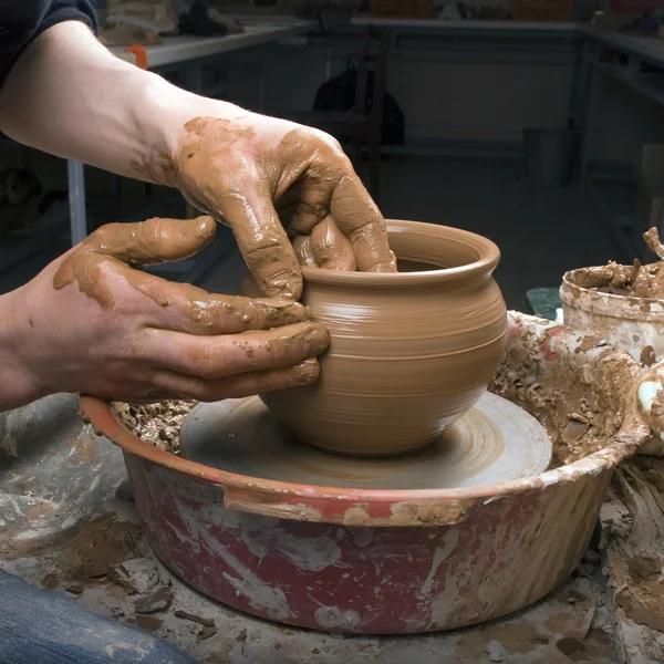 As mãos de um oleiro, criando um jarro de barro no círculo — Fotografia de Stock