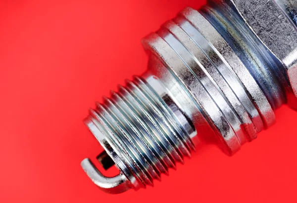 Spark-plug on the red background — Stock Photo, Image